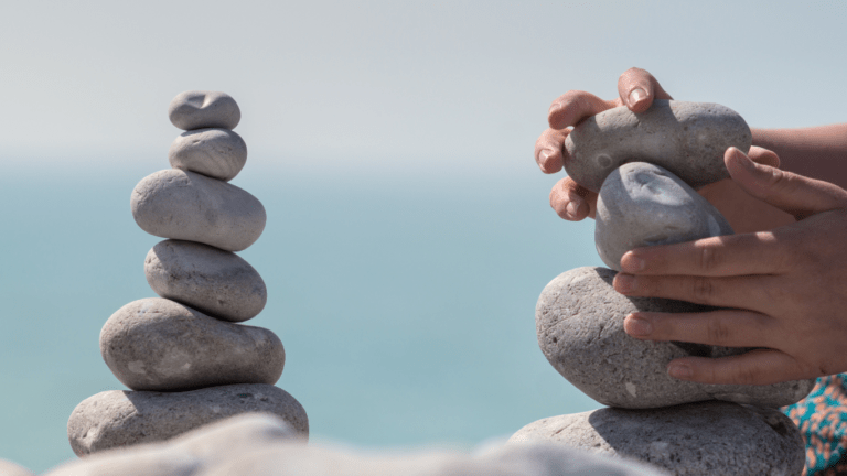 a person stacking rocks on top of each other