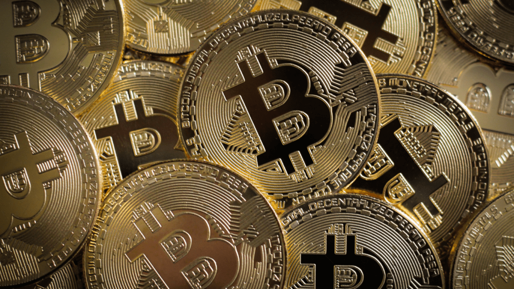 a pile of bitcoin coins on a black background