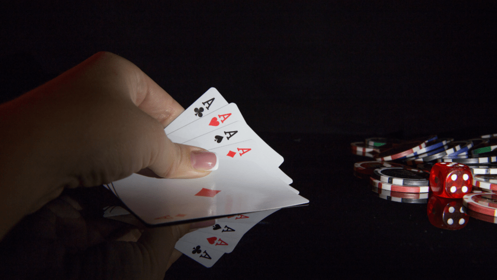 Four aces poker cards and chips on the table