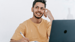 a person sitting in front of a laptop computer