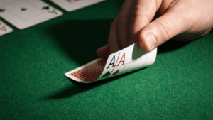 a person holding a pair of playing cards