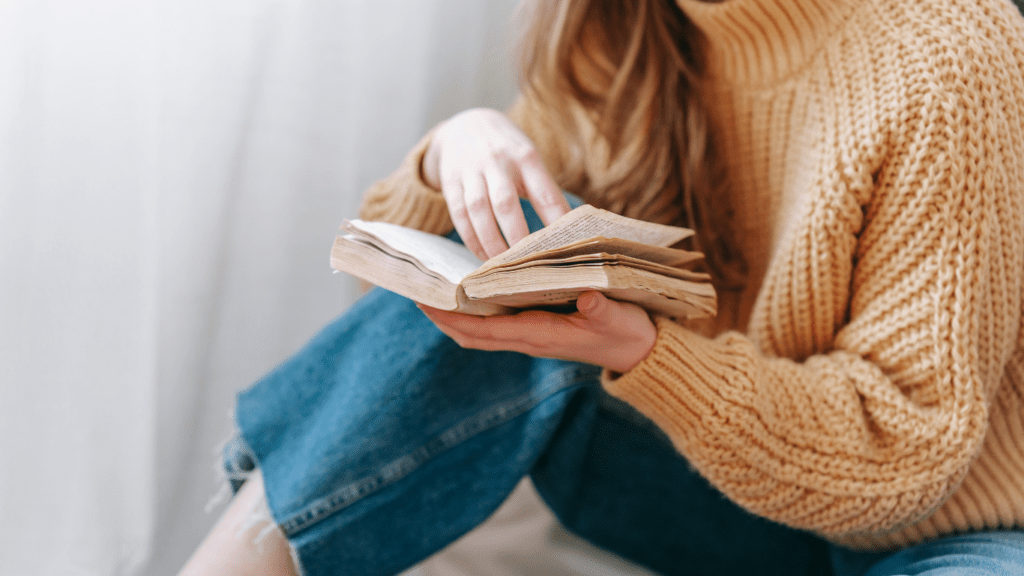 a person holding an open book 