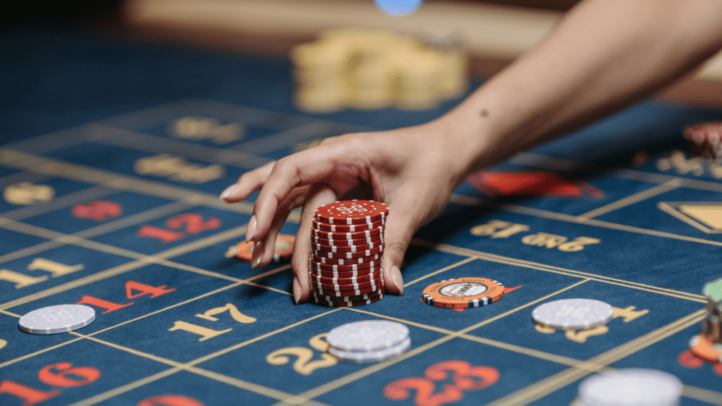 a person playing roulette with chips on a casino table