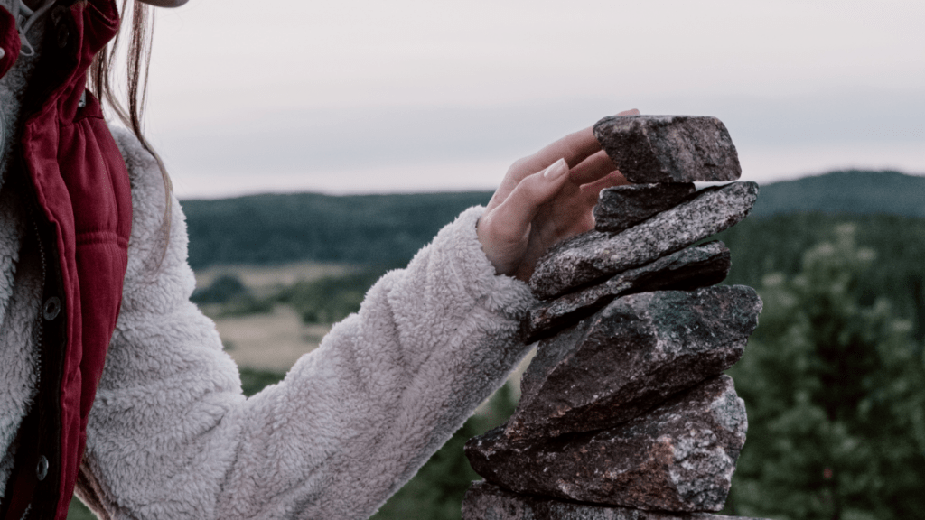 a person stacking rocks on top of each other