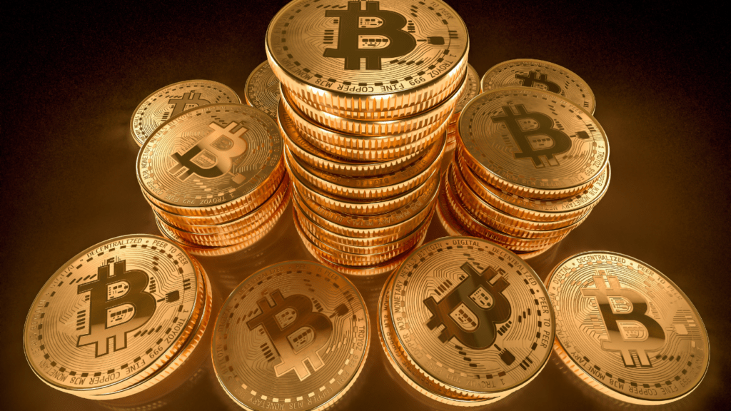 a pile of bitcoin coins on a black background