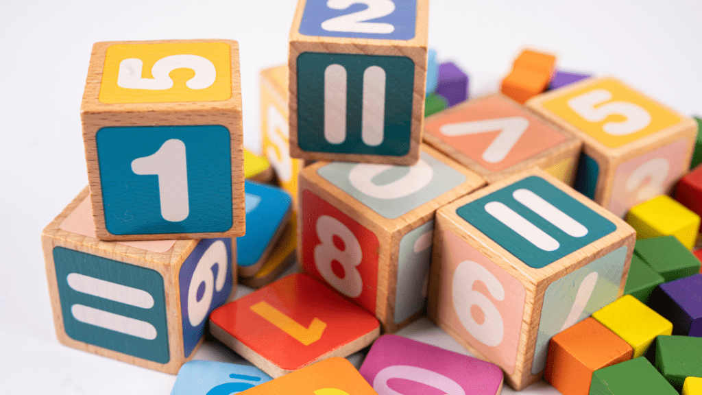 a pile of colorful wooden blocks with numbers on them