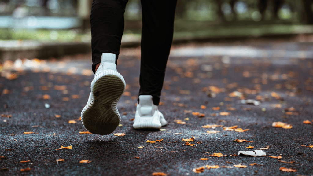 the feet of a person running on a path